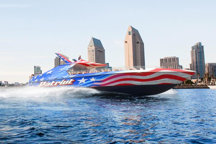 speed boat with backdrop of san diego skyline
