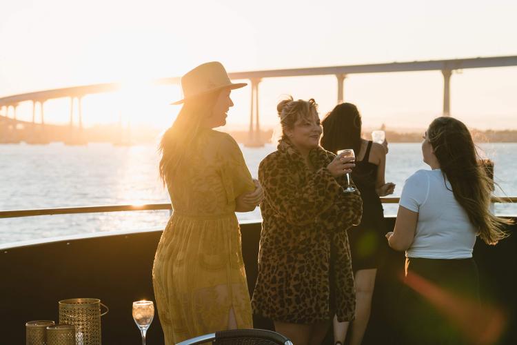 women at sunset on flagship yacht